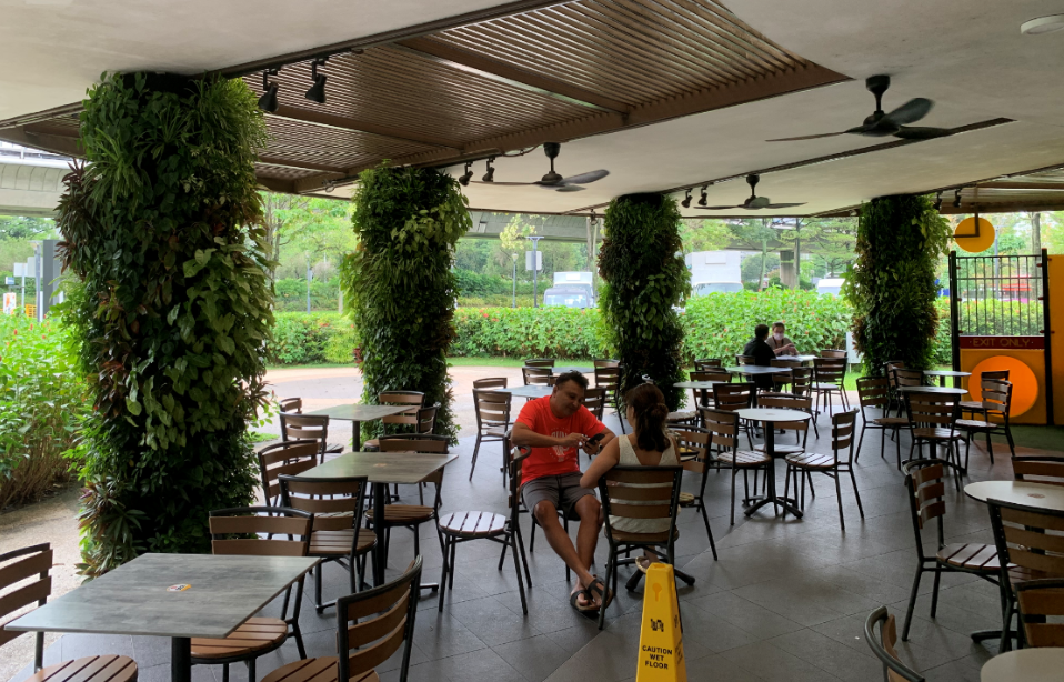 Image shows Mcdonalds at jurong central park, people sitting down admiring the vertical green walls